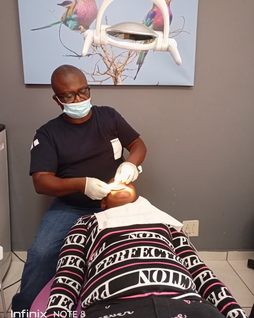 Dr Kutumela discussing a patient's treatment plan during a consultation